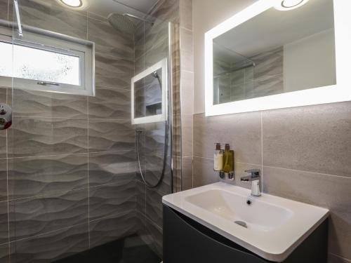 a bathroom with a sink and a mirror at The Hideout in Portree