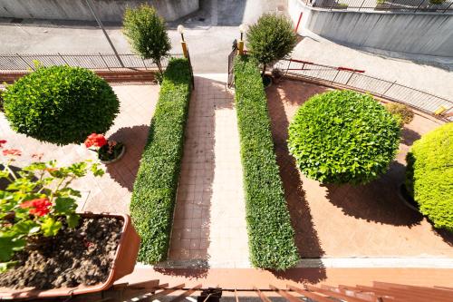 un jardín con arbustos y flores en una acera en Casa Pitara - apartment in vila, en San Martino in Colle