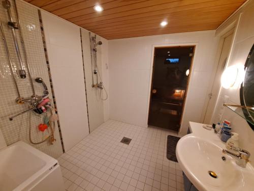 a bathroom with a shower and a sink at Mindfulness Homestay in Espoo in Espoo