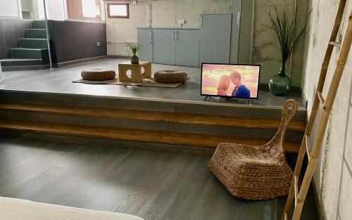 a room with a counter with a tv and a chair at Apartamento rural Castillo de Yeste 2 pax in Yeste