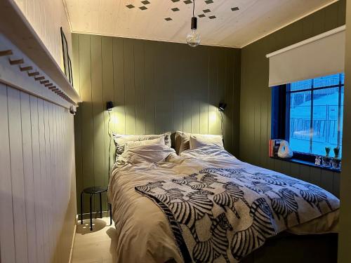 a bedroom with a large bed with green walls at Ljungvind Funäsdalen in Funäsdalen