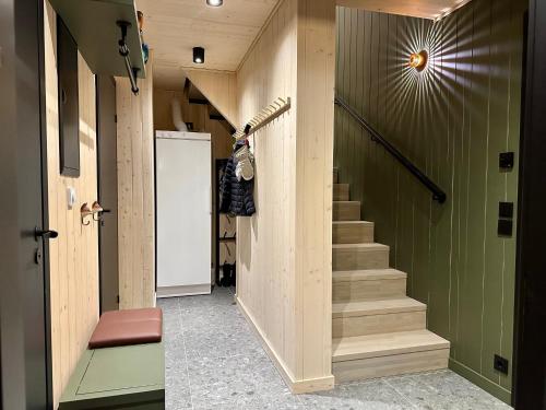a hallway with stairs and green walls at Ljungvind Funäsdalen in Funäsdalen