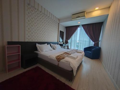a bedroom with a large bed and a window at Ber-Santai @Sky Hotel Suites in Kota Kinabalu