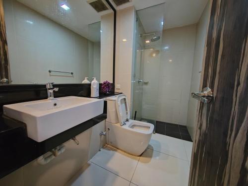 a bathroom with a sink and a toilet at Ber-Santai @Sky Hotel Suites in Kota Kinabalu
