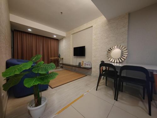 a living room with a table and chairs and a mirror at Ber-Santai @Sky Hotel Suites in Kota Kinabalu