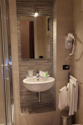 a bathroom with a sink and a mirror at La Terrazza sulla Valle in Agrigento