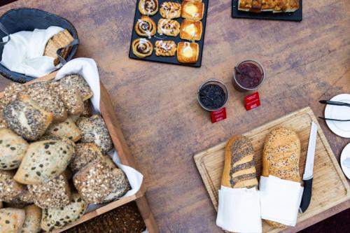 a table topped with different types of bread and pastries at Milling Hotel Park in Middelfart