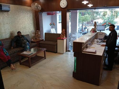 a lobby of a store with people sitting at a counter at Hotel Sun Beam Near Gwalior Railway Station in Gwalior