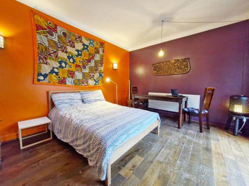a bedroom with a bed and a desk at Coastal - Wittering in West Wittering