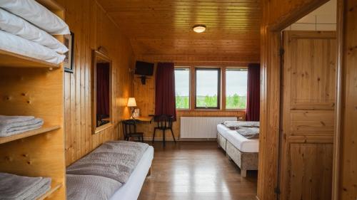 a bedroom with two beds and a window at Árnanes Country Hotel in Höfn