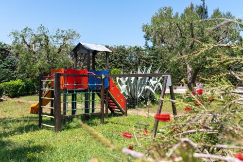 a playground in a park with a play equipment at Relais Porta del Sud in Ostuni