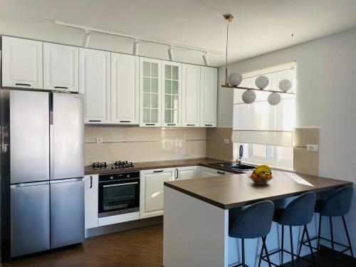 a kitchen with white cabinets and a stainless steel refrigerator at Matić Guest House in Dubrovnik