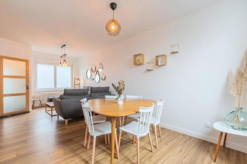 a dining room and living room with a table and chairs at Renovated house with terrace 3 bedrooms in Wasquehal