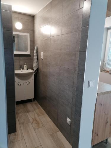 a bathroom with a sink and a mirror at Kerka Szállás in Kerkabarabás