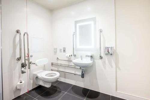 a white bathroom with a toilet and a sink at Hampton By Hilton Blackpool in Blackpool
