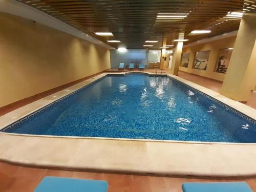 a large swimming pool in a hotel room at Dar Hashim Al Nuzha Serviced Apartments - Economic in Riyadh