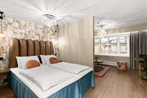 a bedroom with a large bed with a large headboard at Ole Bull, Best Western Signature Collection in Bergen
