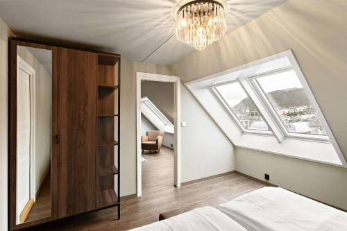 a bedroom with a bed and a chandelier at Ole Bull, Best Western Signature Collection in Bergen