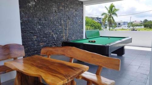 a room with a pool table and a ping pong table at Villa Tobias San Juan Batangas in Batangas City
