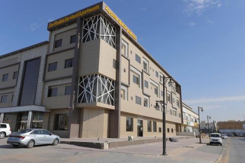 a large building on the corner of a street at Dar Hashim Al Nuzha Serviced Apartments - Economic in Riyadh