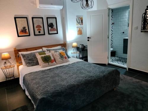 een slaapkamer met een groot bed met kussens bij BayKus Guesthouse-Konukevi in Soke