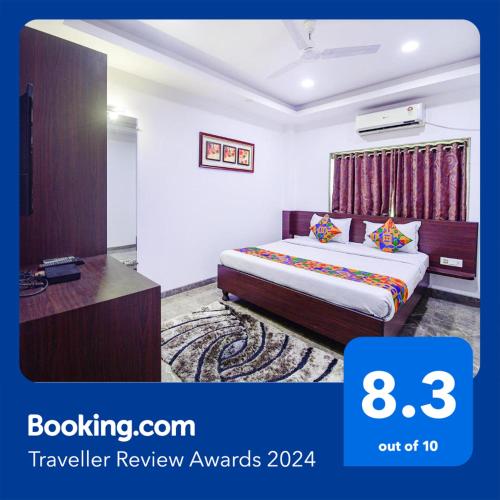 a hotel room with a bed and a desk at FabHotel Rani Tower - Chinar Park in Kolkata