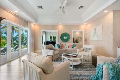 a living room with couches and a table at Gypsy Villa home in Driftwood Village