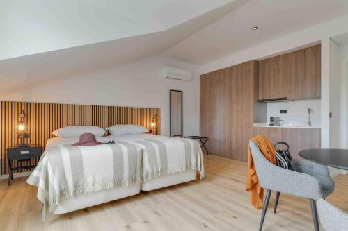 a bedroom with a large bed and a table at Pestana Sintra Golf Resort & SPA Hotel in Sintra