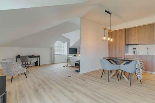 a living room with a table and chairs and a kitchen at Pestana Sintra Golf Resort & SPA Hotel in Sintra