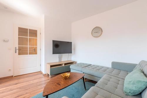 a living room with a couch and a table at Quiet 1 bedroom apartment parking Old Lille in Lille