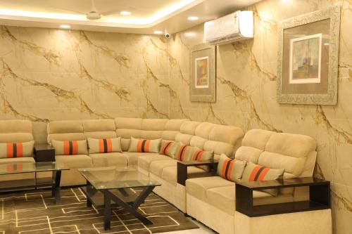 a living room with a couch and two tables at HOTEL SR in Palani