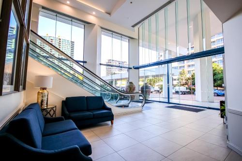 an empty lobby with escalators in a building at Dockside Brisbane in Brisbane
