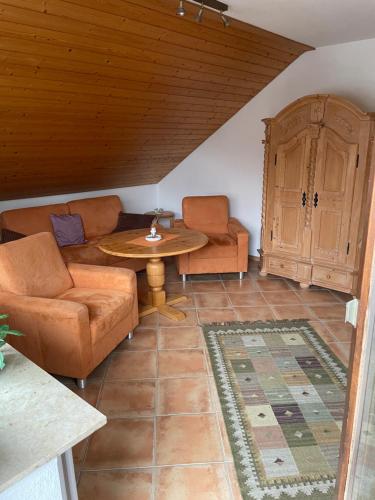 a living room with a couch and a table at Titiseehnsucht - Gemütliche Wohnung mit Parkplatz in Titisee-Neustadt