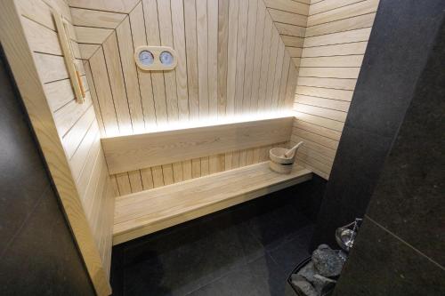 a wooden sauna with a bench in a bathroom at Vividlux Apartments in Arandjelovac