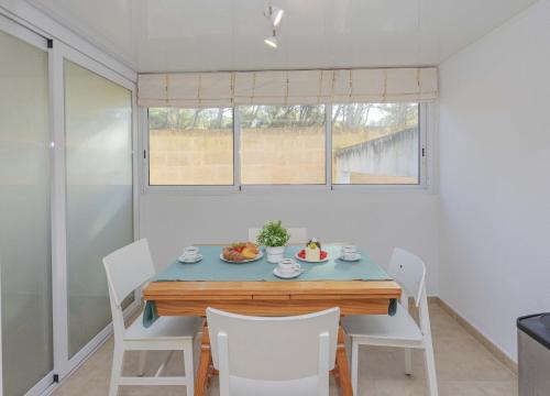 a dining room with a blue table and chairs at Can Bennasar in Can Picafort