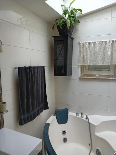 een badkamer met een wit bad en een wastafel bij ROSE Room of 40m2 with terrace 25m2 in Ljubljana