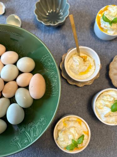 a green bowl of eggs and a bowl of dip at Wellness apartmány Český ráj & Biokolna in Lomnice nad Popelkou