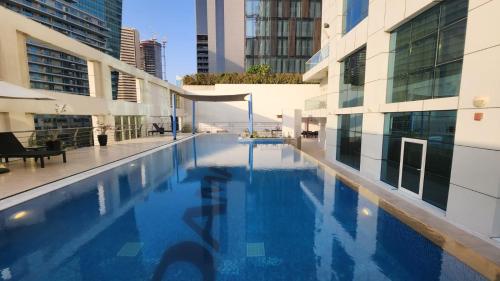 a swimming pool in the middle of a building at DAMAC Park Central in Business Bay in Dubai