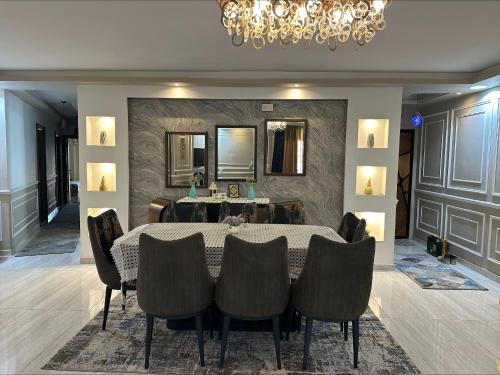 a dining room with a table and chairs and a chandelier at Luxurious apartment in cairo in Cairo