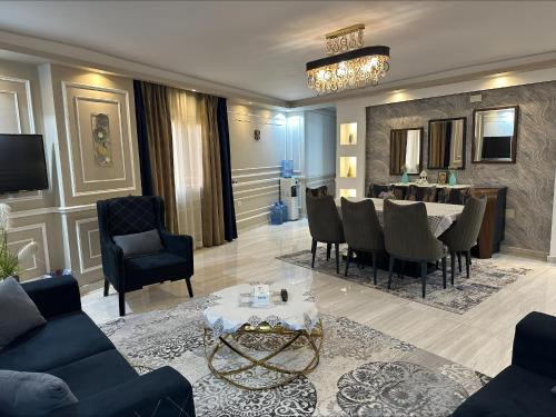 Luxurious apartment in cairo في القاهرة: غرفة معيشة مع طاولة وغرفة طعام