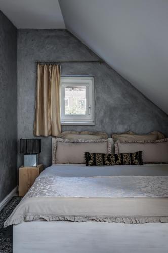 a bedroom with a large bed with a window at Wellness apartmány Český ráj & Biokolna in Lomnice nad Popelkou