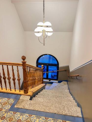 a home with a staircase and a chandelier at außergewöhnliche Ferienwohnung Stadtvilla Plauen in Plauen
