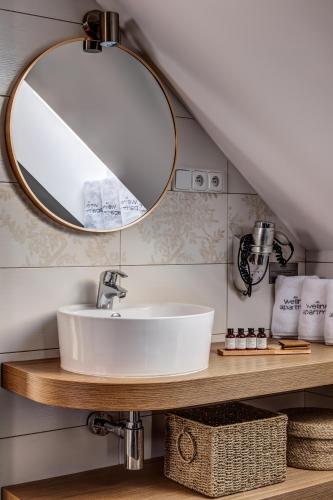 a bathroom with a sink and a mirror at Wellness apartmány Český ráj & Biokolna in Lomnice nad Popelkou