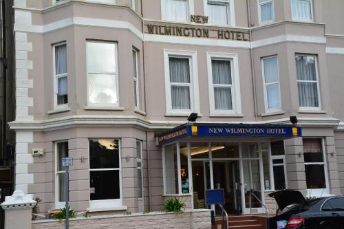 a building with a newminster hotel on the street at New Wilmington Hotel in Eastbourne