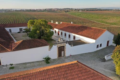 an aerial view of a white house with red roofs at Quinta da Lapa in Manique do Intendente