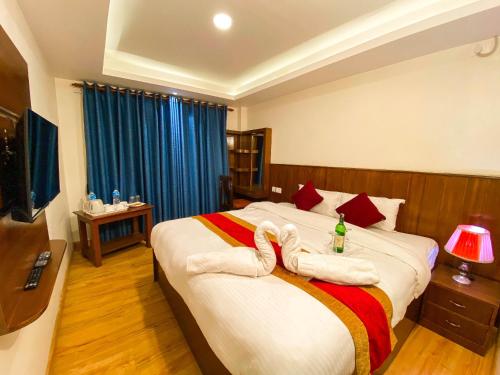 a hotel room with a bed with towels on it at Hotel Abi International in Kathmandu