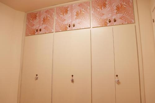 a row of white cabinets in a room at Apartamento El Mercado in Alcañiz