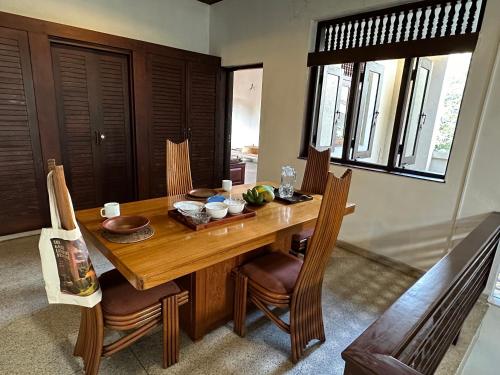 a dining room table with chairs and a wooden table at Hotel 106 in Colombo