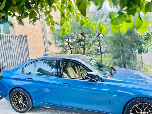 a blue car parked on the side of a street at Private 3 BHK - Woodstock Villa Amritsar in Amritsar