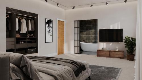 a bedroom with a tub and a television and a bed at Luxurious New Build in Nottingham